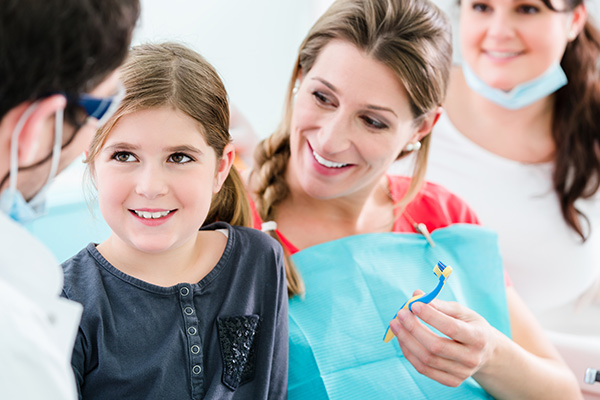 A woman with her child at a dentist office