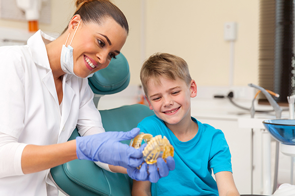 A child with a dental professional preparing for braces. 