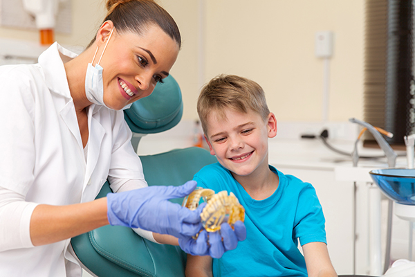 A child with a dental professional preparing for braces.
