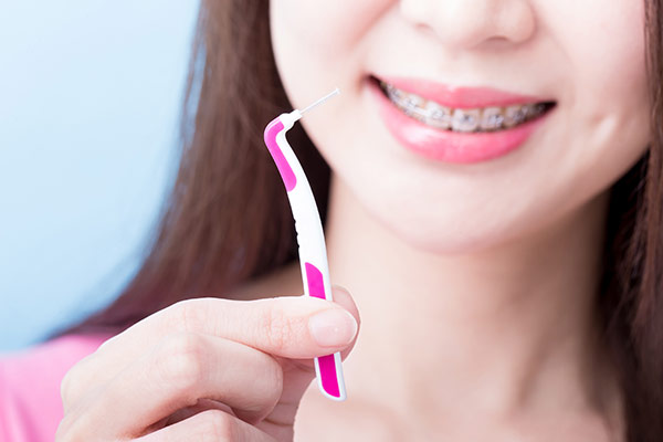 A woman holding an interdental brush