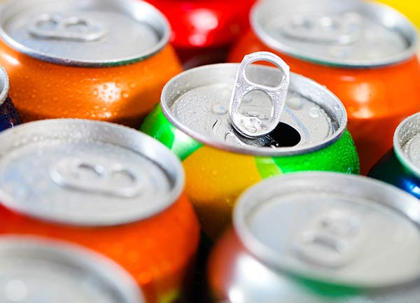 Cans of soda wet with condensation