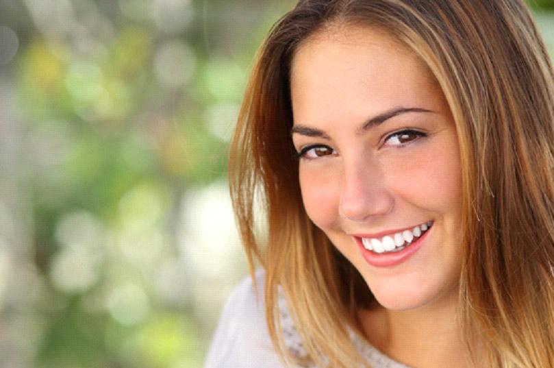 young woman with perfect teeth smiling